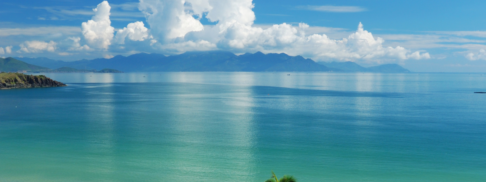 The file shows a Hawaiian landscape featuring a wide expanse of blue ocean with a distant mountain range. The water is calm and clear, while the mountains rise gently, creating a peaceful, scenic view of the island’s natural beauty.